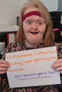 Marion - an individual we support holding a page with writing to say she is getting her vaccine